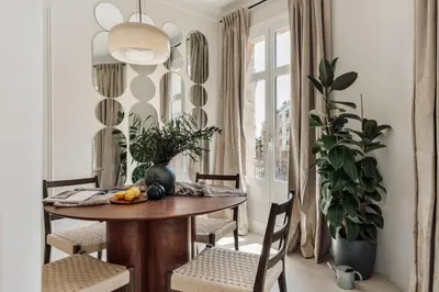 a dining room with a wooden table and chairs at Pavona - 2 bedrooms and terrace in Sants in Barcelona