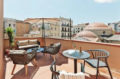 a living room with a couch and a table at Pavona - 2 bedrooms and terrace in Sants in Barcelona