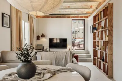 a living room with a couch and a table at Gandoc - 3 bedrooms and terrace in Sants in Barcelona