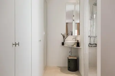 a bathroom with white walls and a white sink at Gandoc - 3 bedrooms and terrace in Sants in Barcelona