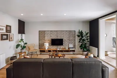a living room with a couch and a tv at Feshi - 3 bedrooms in Eixample Dreta in Barcelona