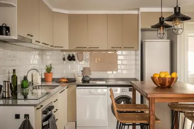 a kitchen with a wooden table and a refrigerator at Remy - 2 bedrooms and terrace in Eixample Dreta in Barcelona