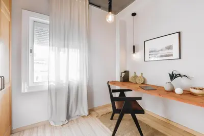 a home office with a wooden desk and a window at Rio Doce - 1 bedroom and terrace in Gòtic in Barcelona