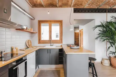 a living room with a couch and a table at Rio Doce - 1 bedroom and terrace in Gòtic in Barcelona
