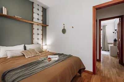 a kitchen with two stools under a counter at Cortijo - 2 bedrooms in Gràcia in Barcelona