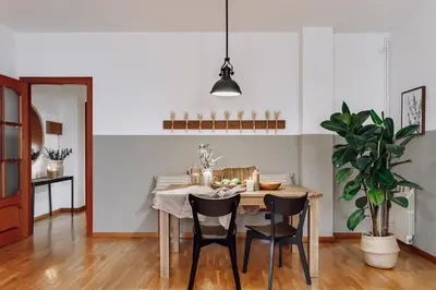 a living room with a white couch with pillows at Cortijo - 2 bedrooms in Gràcia in Barcelona