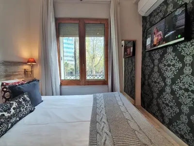 a bedroom with a large bed and a window at DreamKeys Barcelona City in Barcelona