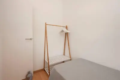 a white room with a bed and a mirror at Beach vibes in Castelldefels in Castelldefels