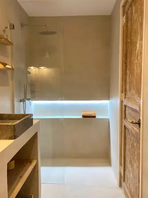 a bathroom with a shower with a glass door at New penthouse duplex by the sea in Masnou