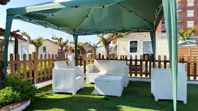 a facade of a beach club with a building at Camping Costa Dorada in Canet de Mar