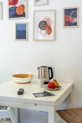 a kitchen counter with a coffee maker and fruits on a table at Canela Homes COSTA PALMERES in Castelldefels