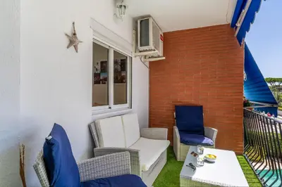 a patio with two chairs and a table on a balcony at Canela Homes COSTA PALMERES in Castelldefels
