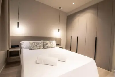 a bedroom with a large white bed with two pillows at Sagrada família essence in Barcelona