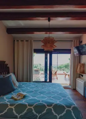 a bedroom with a large bed and a large window at Pergola Suite - Boutique Retreat Loft Barcelona Coast Panoramic Sea View in Sant Andreu de Llavaneres
