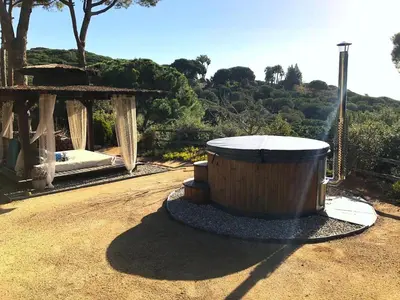 a large wooden tub sitting on top of a dirt road at Pergola Suite - Boutique Retreat Loft Barcelona Coast Panoramic Sea View in Sant Andreu de Llavaneres