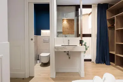 a bathroom with a sink and a toilet at Colon Deluxe con Piscina cerca del Mar in Barcelona