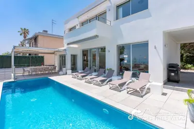a villa with a swimming pool and a house at Cool & Modern Villa Giovanna with Air Conditioning, Private Pool & Sea Views in Sitges