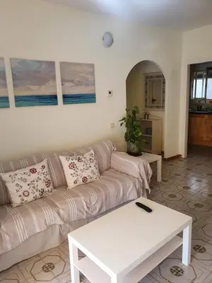 a living room with a couch and a table at Apartamento Luminoso en el Centro de Sitges in Sitges