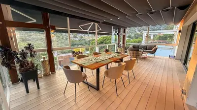 a dining room with a table and chairs on a deck at Villa Marina in Sitges