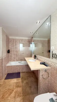 a bathroom with a sink and a tub and a mirror at Villa Marina in Sitges