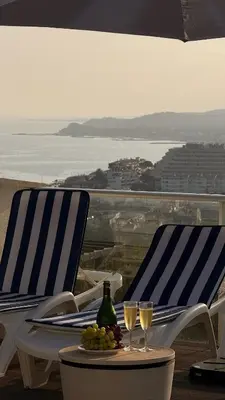 two chairs and a table with two glasses of wine at Villa Marina in Sitges
