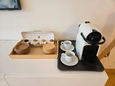 a coffee maker and two cups and a box of cookies at Aquamarina Apt | Seaviews | 1' beach | Family in San Pol de Mar