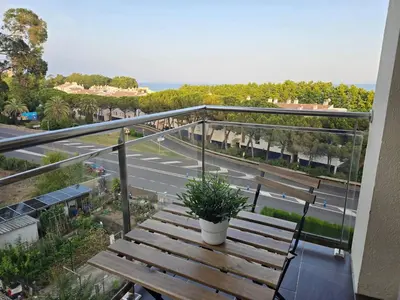 a balcony with a wooden table and benches on it at Aquamarina Apt | Seaviews | 1' beach | Family in San Pol de Mar