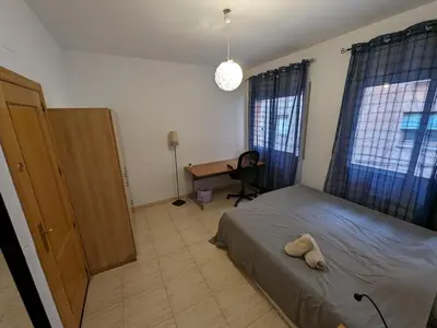 a bedroom with a bed with a stuffed animal on it at Large and calm 3 bedroom apartment with terrace in Barcelona