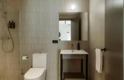 a bathroom with a toilet and a sink and a mirror at Lixar's apartment in Hospitalet de Llobregat