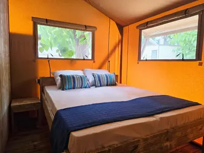 a bathroom with a sink and a shower and a toilet at Camping Costa Dorada Tienda Aura in Canet de Mar