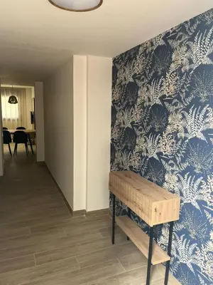 a hallway with a blue and white patterned wall at Tr3sor B2 in Calella