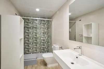 a white bathroom with a sink and a toilet at Tr3sor B2 in Calella