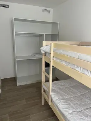 a room with two bunk beds and a closet at Tr3sor B2 in Calella