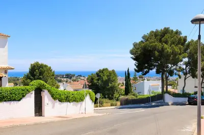 a street with a white fence with ivy on it at Villa Carmen - Peaceful Eco-Luxury with private pool in Cunit