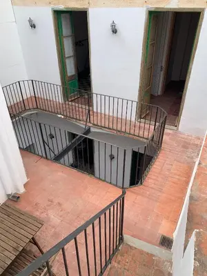 an empty hallway with a staircase in a building at Casa l'àvia - Sant Pol de Mar in San Pol de Mar