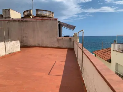 a large patio with the ocean in the background at Casa l'àvia - Sant Pol de Mar in San Pol de Mar