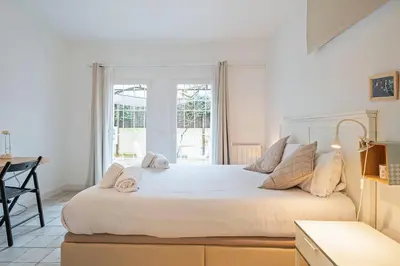 a bedroom with a large bed with towels on it at Winahost Apartament Cirerer in Valldoreix
