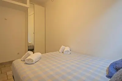 a bedroom with a bed with towels on it at Winahost Apartament Cirerer in Valldoreix