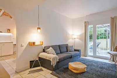 a living room with a blue couch and a table at Winahost Apartament Cirerer in Valldoreix