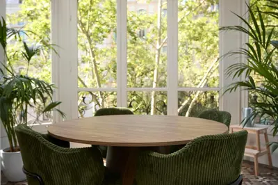 a wooden table and chairs in front of a window at 12DIA1008 - Fantastic Apartment in Diagonal in Barcelona