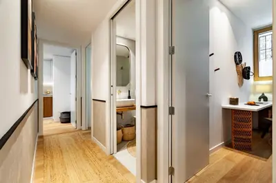 a mirror over a bed in a bedroom at Tinghir - 2 bedrooms and pool in Gràcia in Barcelona