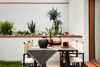 an outdoor patio with lounge chairs and tables at Tinghir - 2 bedrooms and pool in Gràcia in Barcelona