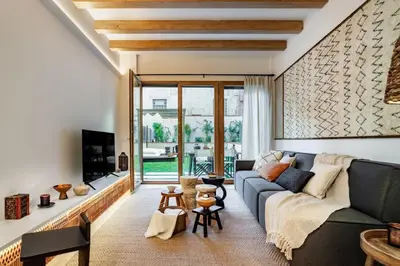 a bedroom with a large bed and two windows at Tinghir - 2 bedrooms and pool in Gràcia in Barcelona