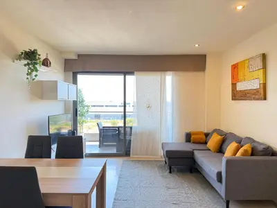 a living room with a couch and a table at Dúplex con encanto en Castelldefels in Castelldefels