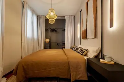 a hammock on a balcony with a table and chairs at Atacama - 1 bedroom in Eixample Esquerra in Barcelona