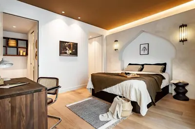 a kitchen with white cabinets and black appliances at Tenere - 1 bedroom and pool in Gràcia in Barcelona