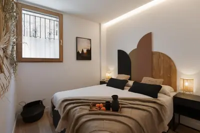 a patio with a swimming pool and two chairs at Lingga - 2 bedrooms and terrace in Gràcia in Barcelona