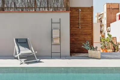 two chairs and a table in a room with stairs at Lingga - 2 bedrooms and terrace in Gràcia in Barcelona