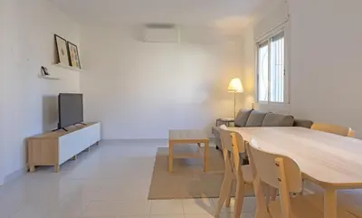 a dining room and living room with a table and chairs at Winahost Barcelona Sants in Barcelona
