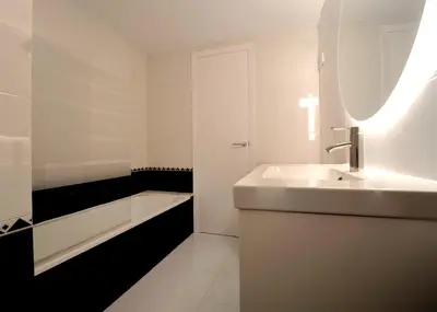 a white bathroom with a sink and a bath tub at Winahost Barcelona Sants in Barcelona